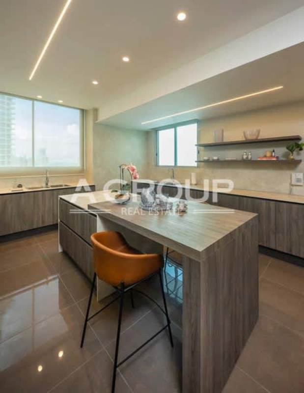 Spacious modern open living and dining area with floor-to-ceiling windows and ocean views in Pacific Point Tower 400 Punta Pacifica Panama
