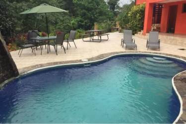 Covered terrace with hammocks overlooking lush gardens at luxury mountain villa Altos del María Panama