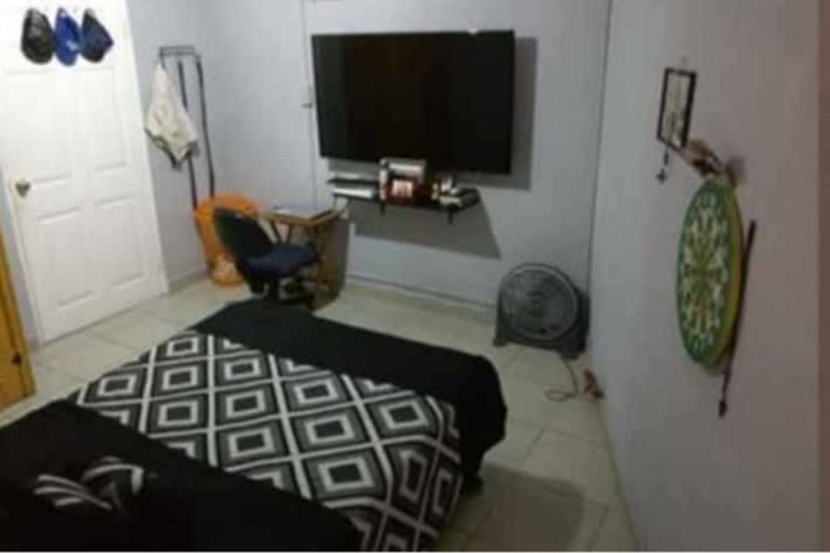 Bedroom with king bed, wood furniture, AC, curtains in Altos de Cerro Viento Panama