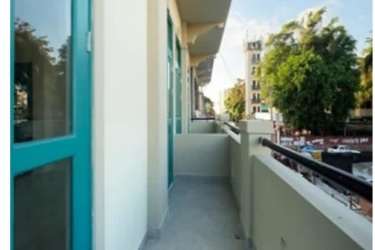 Balcony with railing outside apartment overlooking city street La Quince Santa Ana Panama
