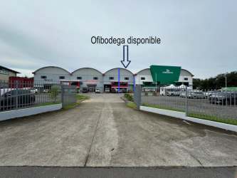 Exterior facade of warehouse rental with parking spaces and secure fencing in San Pablo Nuevo David Panama