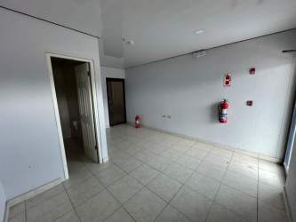 Empty commercial interior area with white walls tiled floors for offices or warehousing in David Panama