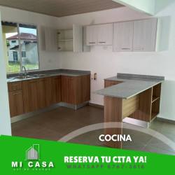 Kitchen with L-shape counters, wood finish cabinets, breakfast bar in Residencial Reserva Santiago