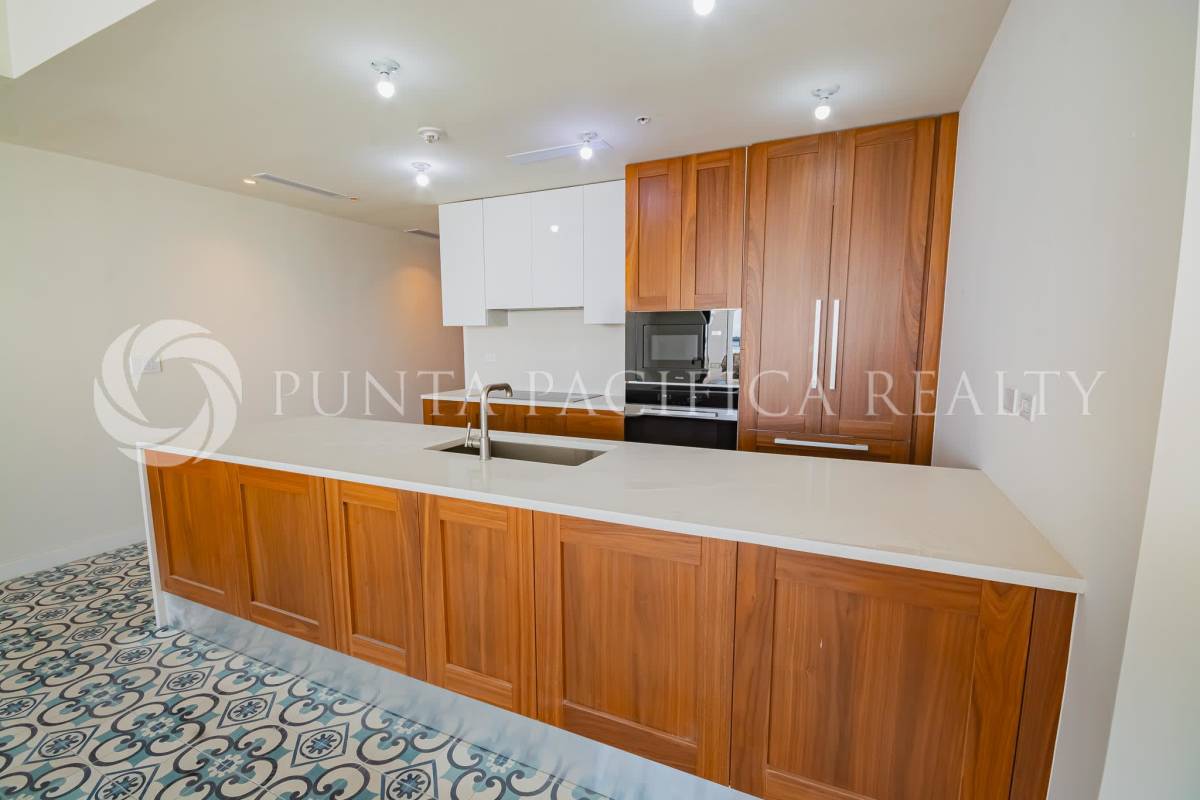Open modern kitchen with island, wood cabinets, tile flooring PH Santa Familia Casco Viejo