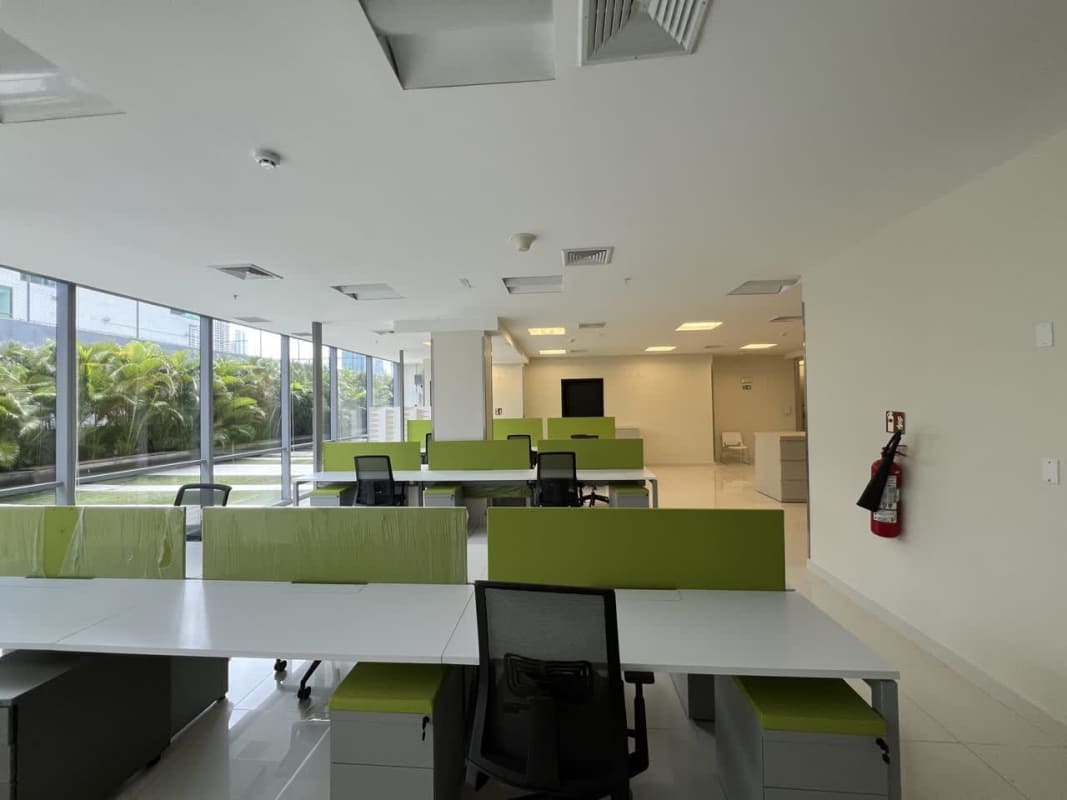 Small enclosed conference room with meeting table and chairs in Costa del Este corporate office