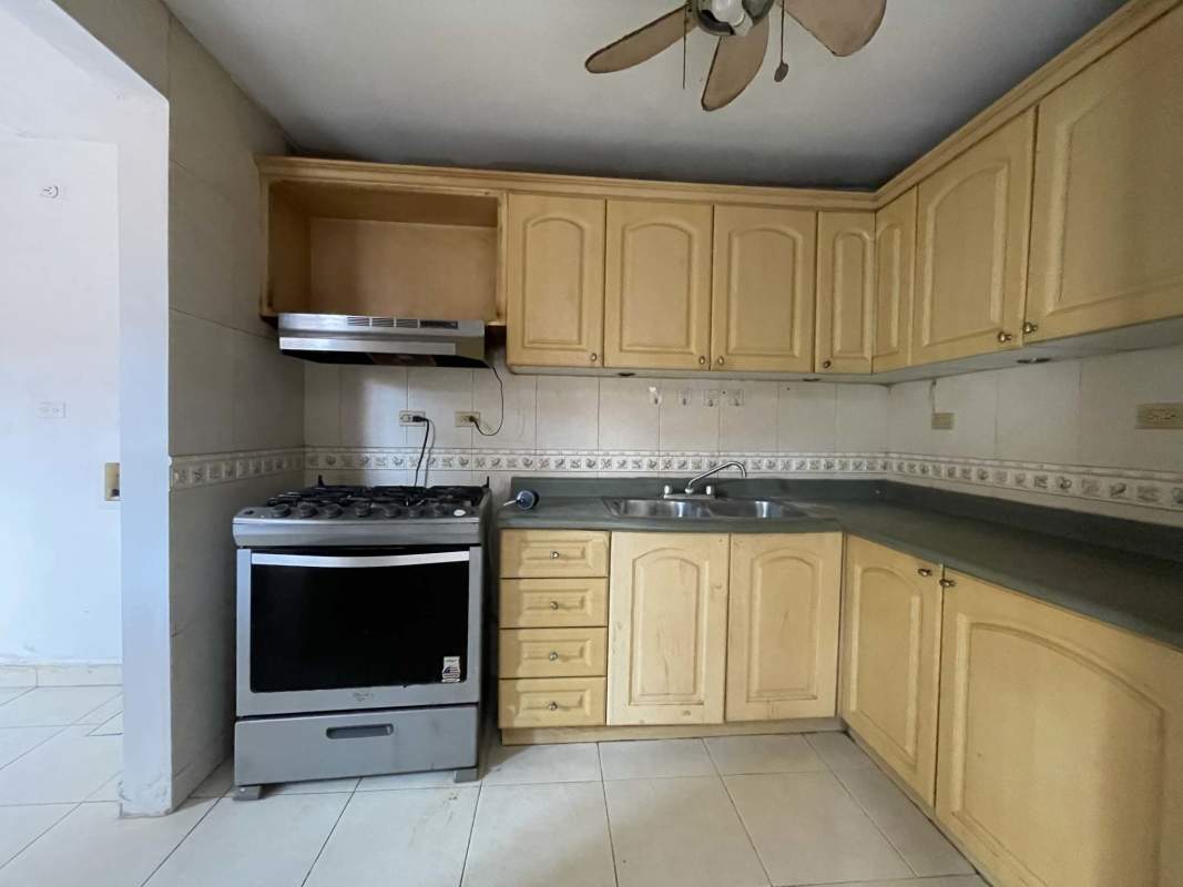 Kitchen with wooden cabinets gas stove backsplash tile Condado del Rey Panama