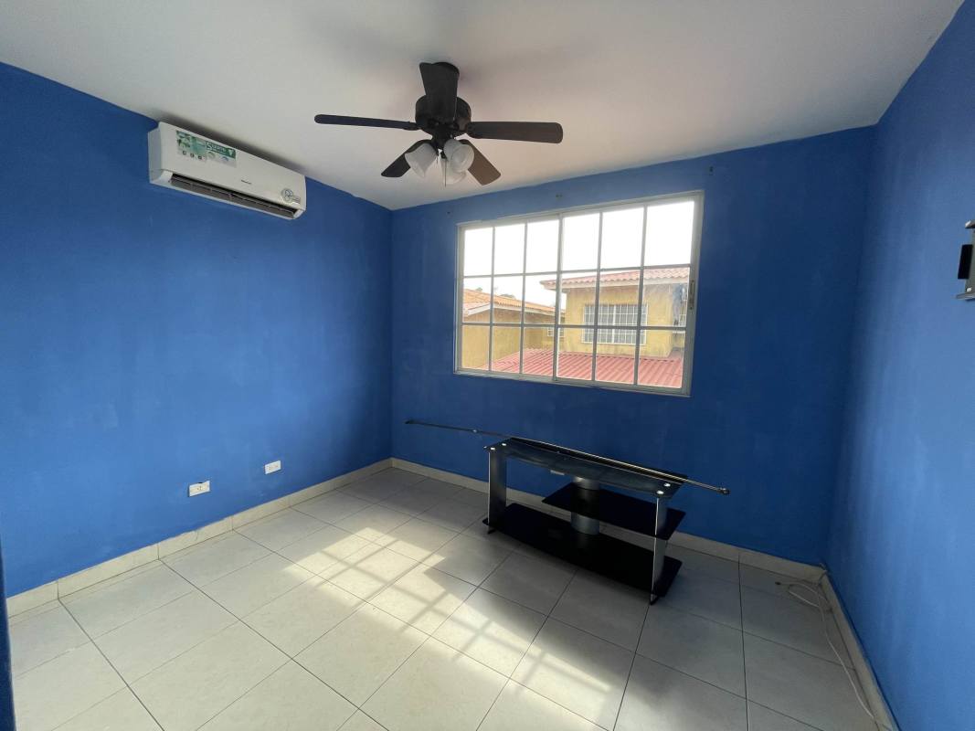 Bedroom with split AC ceiling fan built-in wardrobe green walls Dorado Lake Panama