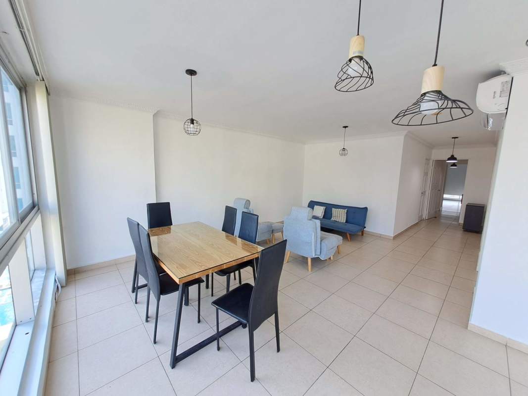 Spacious living and dining room with ceramic tile floors and balcony access at PH Sol del Este