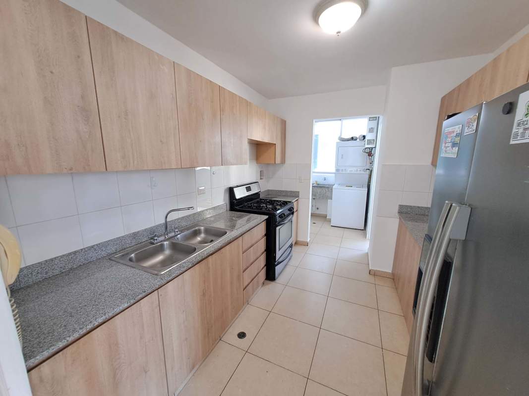 Closed kitchen featuring granite countertops and ample storage in PH Sol del Este Costa del Este Panama