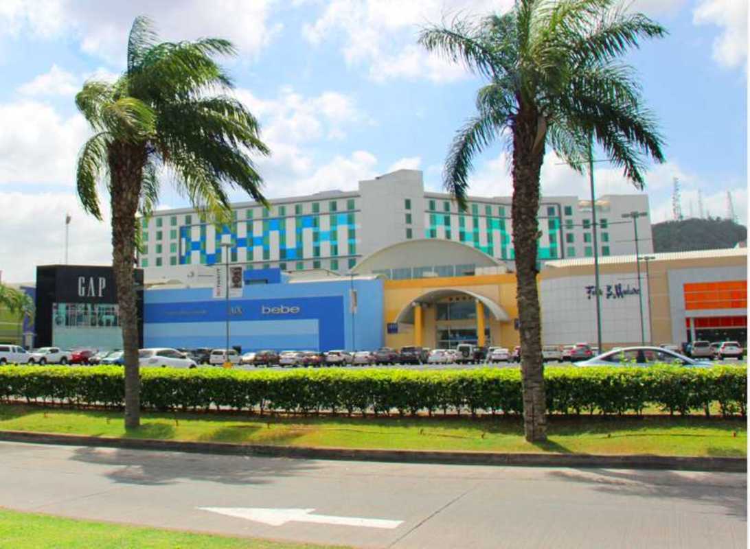 Drone aerial of expansive Albrook Mall retail and warehouse with adjacent runway Panama