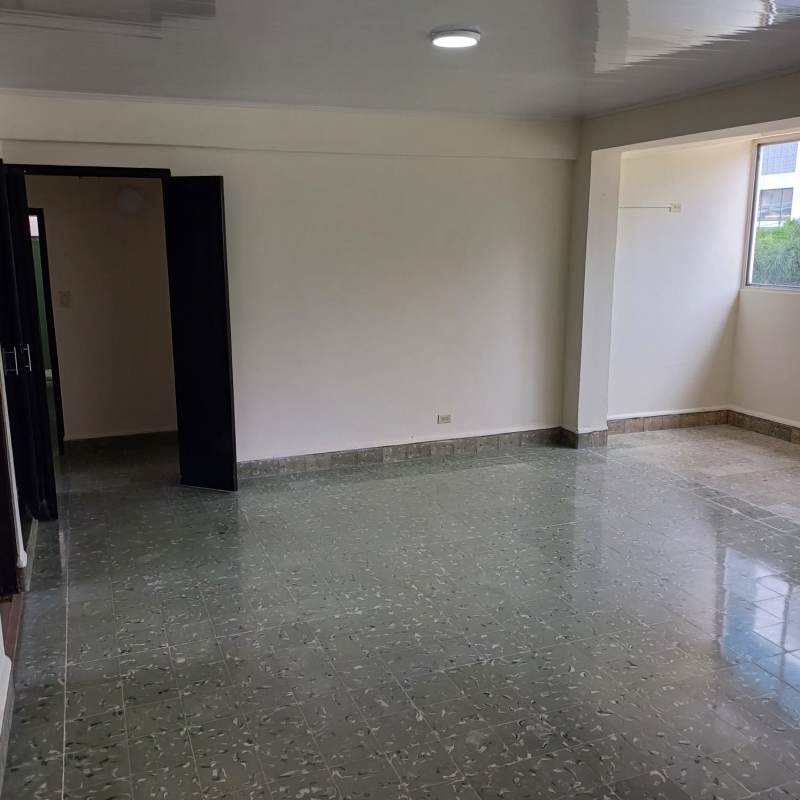 Kitchen with black cabinets, yellow backsplash, large window PH Obarrio Plaza