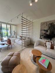 Elegant living area with large windows, neutral decor and high ceilings in Panama Pacifico Howard house