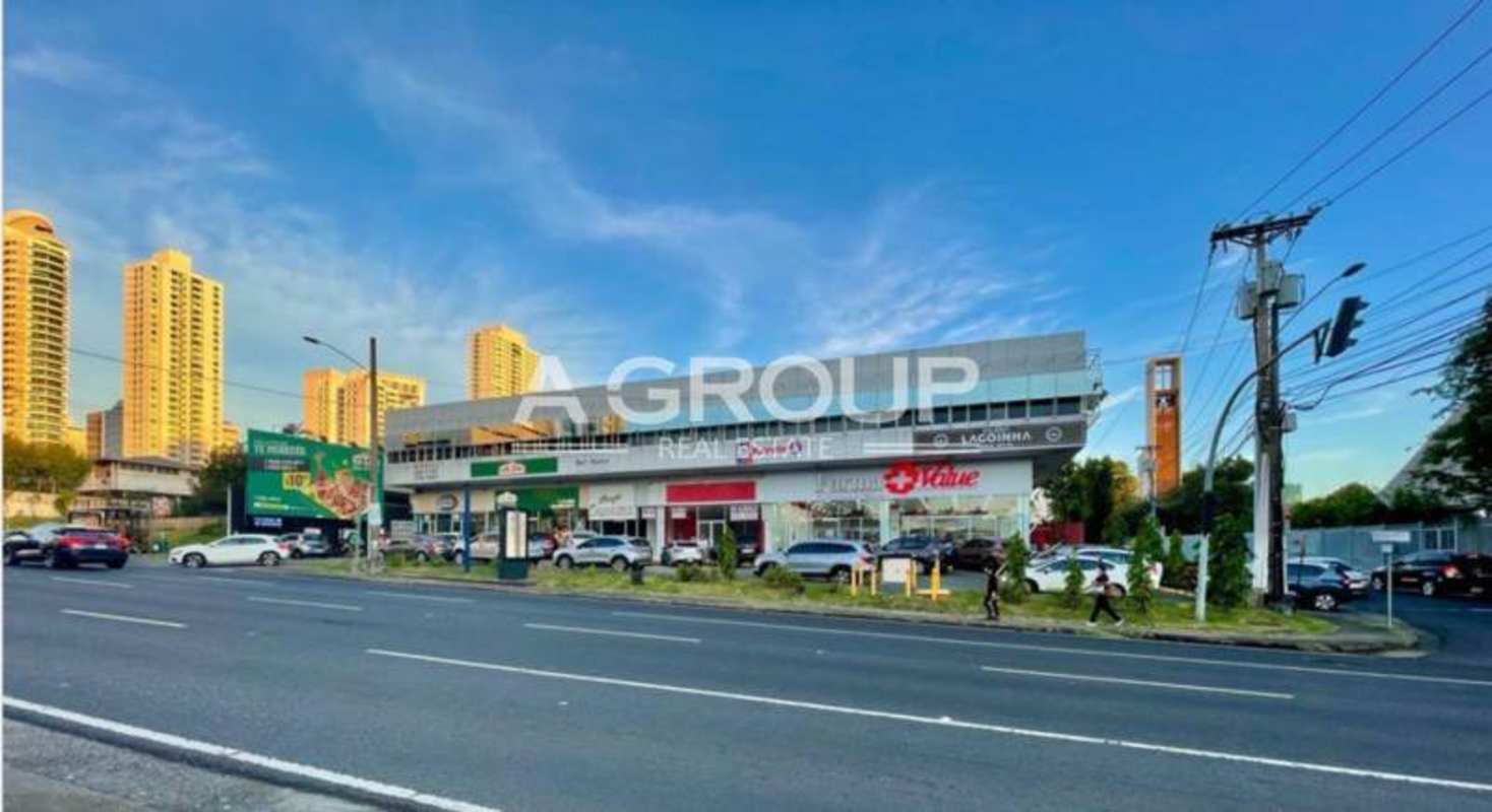 Front view of commercial plaza with multiple retail storefronts and parking along Calle 50 Obarrio Panama City