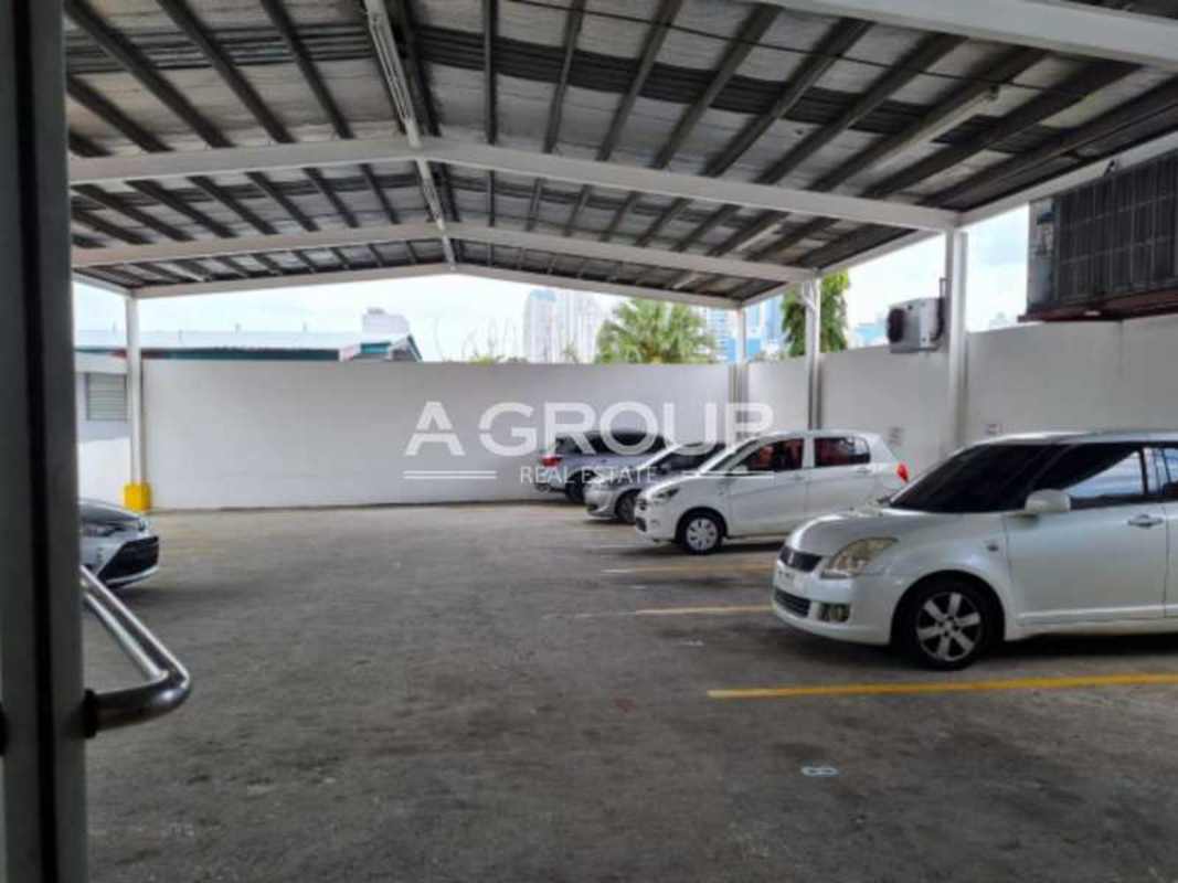 Commercial building facade with multiple signage and retail units on Calle 50 Panama