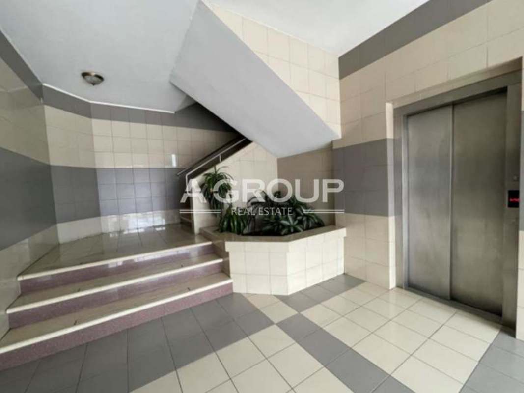 Secure covered parking under metal roof with city skyline visible at commercial plaza Obarrio Panama City