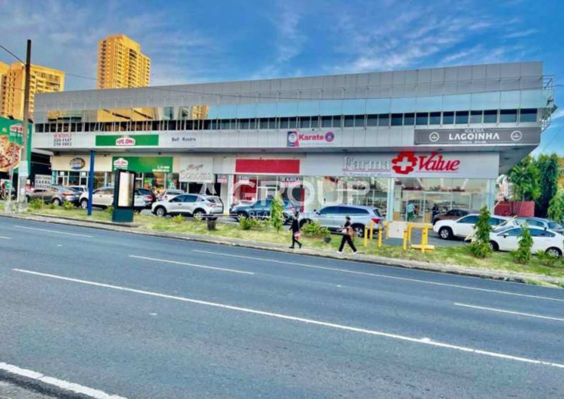 Exterior facade of retail storefronts glass windows signage parking Plaza Commercial Calle 50