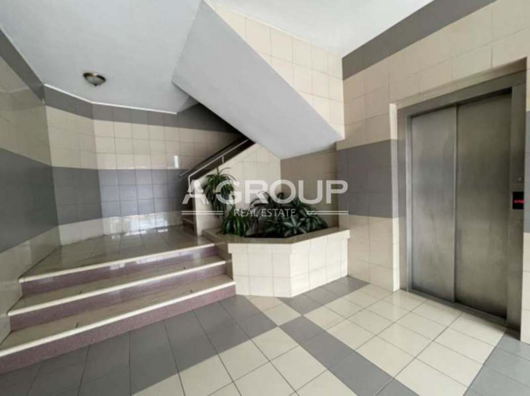 Two-story commercial plaza with glass retail units parking and signage Calle 50 Obarrio Panama