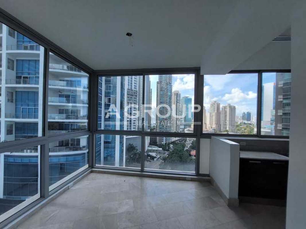 Modern hallway with curved floor-to-ceiling glass overlooking sea and skyline PH Grand Tower Punta Pacifica