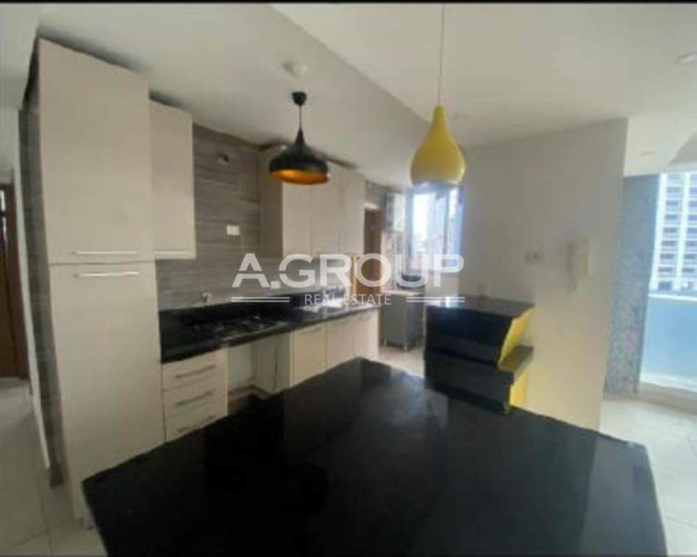 Modern kitchen with granite countertops, built-in cabinetry, and breakfast bar PH Park City Obarrio Panama