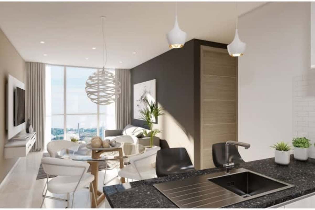 High rise eco condo tower with glass balconies in lush Green City Panama Norte community