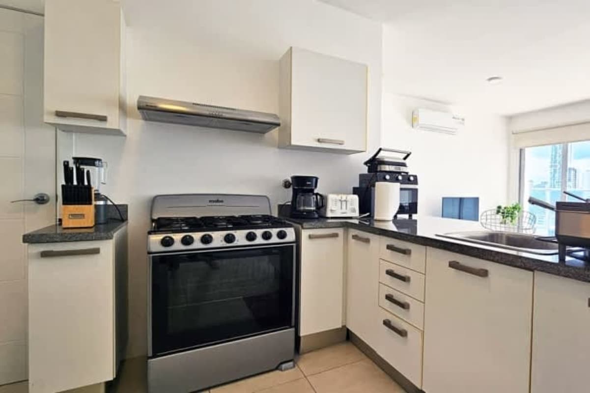 Kitchen with granite countertops stainless steel appliances PH Waters On the Bay Panama