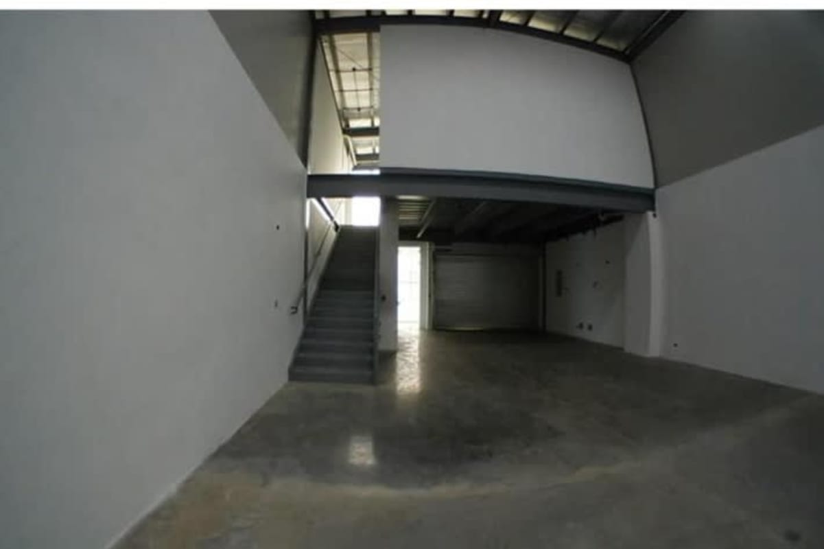Warehouse space featuring mezzanine level with industrial staircase at Panama Viejo Business Center Panama City