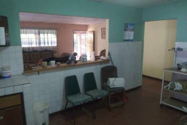 Traditional kitchen with stove and dining space in affordable home Lidice Capira Panama