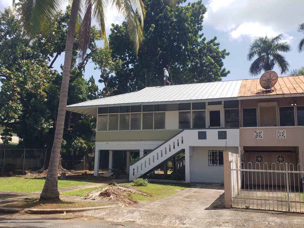 Mid-century tropical elevated house metal roof duplex rental Panama Balboa