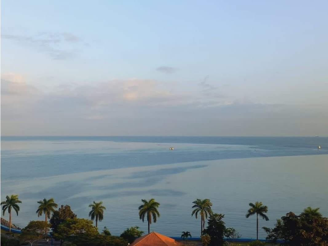 Living room with floor-to-ceiling windows panoramic ocean skyline views PH Rivage