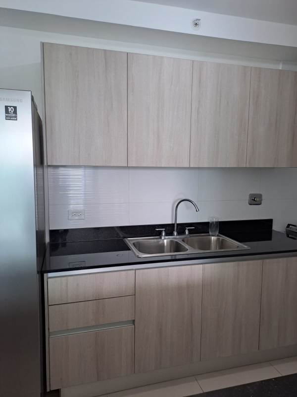 Contemporary kitchen with granite counters, double sink, refrigerator in PH Coral Plaza Panama