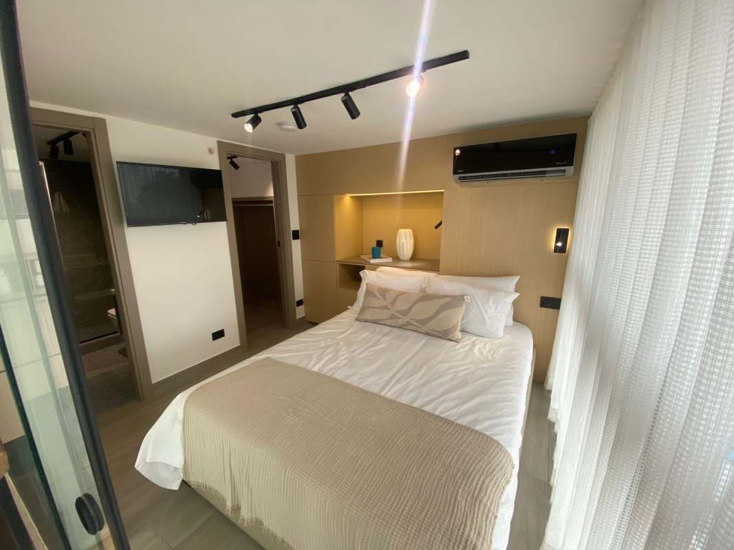 Compact modern kitchen with granite countertop and dining area inside loft apartment at PH Dovle Coco del Mar