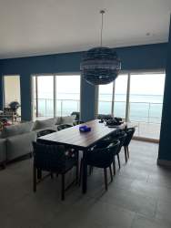 Spacious living and dining area with large windows and ocean view Playa Escondida Portobelo Panama