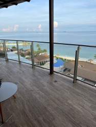 Large modern living room with sectional sofa and ocean view at Playa Escondida Beach Condo Panama
