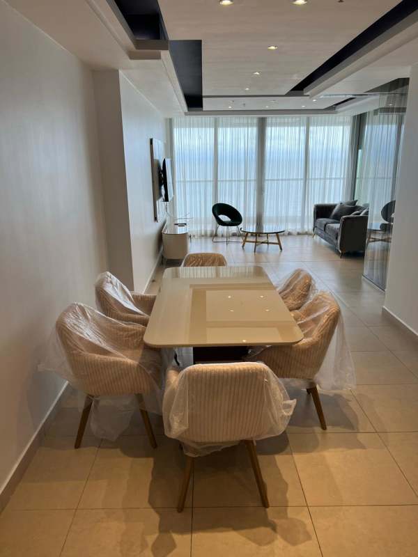 Furnished master bedroom with ocean view floor-to-ceiling windows in PH BICSA Tower Panama