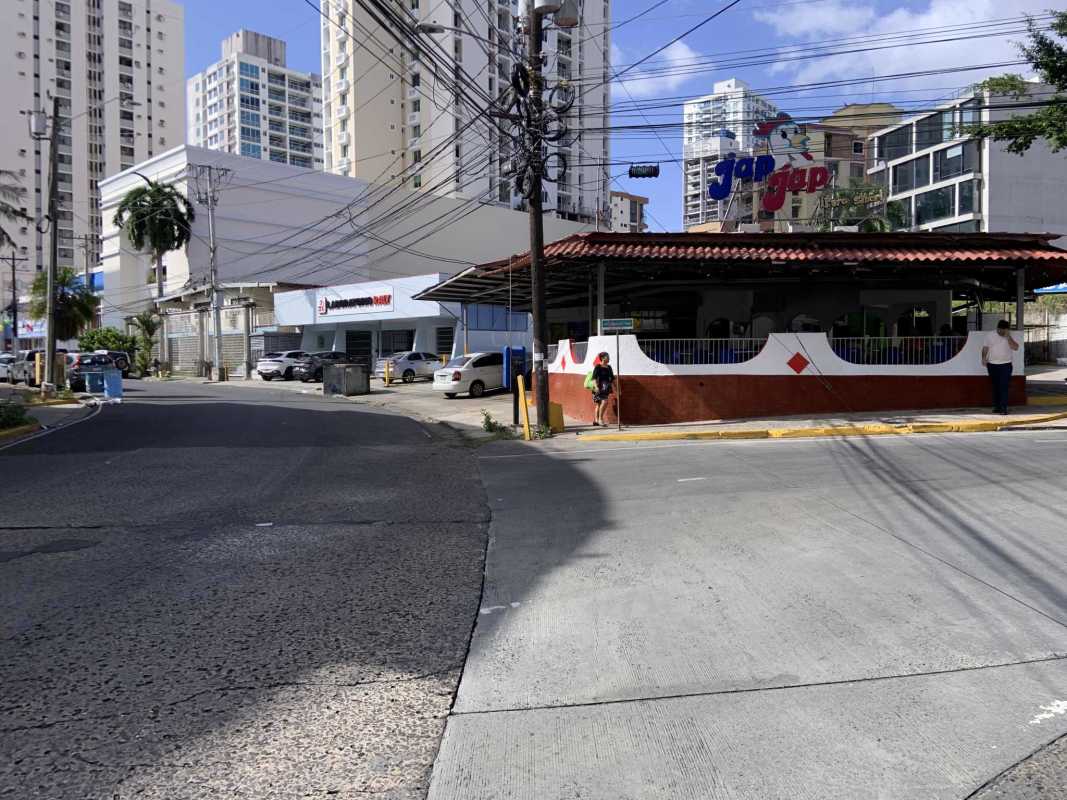 Busy urban street featuring available corner land plot in El Cangrejo commercial district Panama City