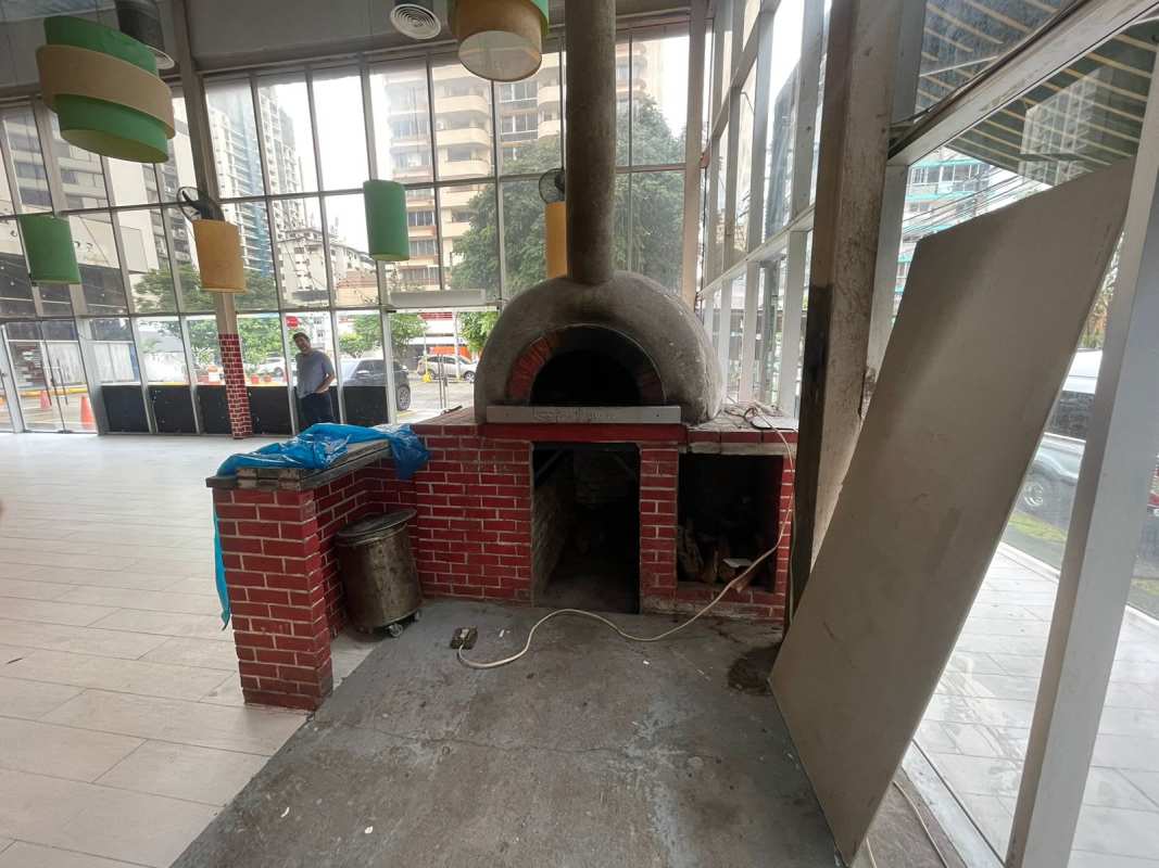 Commercial dining space with brick pizza oven and floor to ceiling windows in Plaza Downtown El Cangrejo Panama