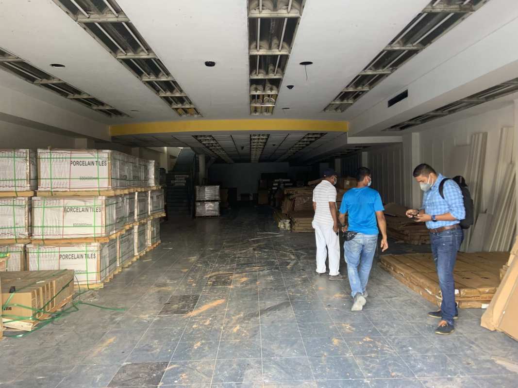 Street view of retail commercial space with glass facade and security shutters on Avenida Peru Calidonia Panama