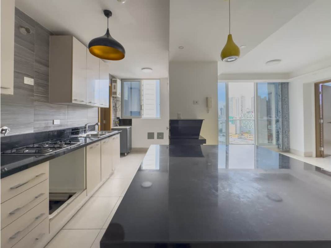 Modern kitchen with granite counter, open layout and island at PH Park City in Obarrio Panama
