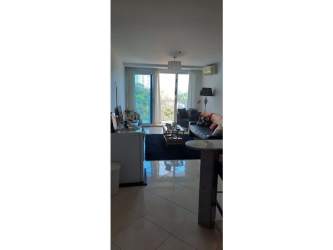 Living room with sliding glass doors to ocean view balcony at PH Ibiza Playa Corona Panama