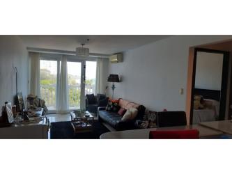 Living room with sofa and balcony view in beachfront condo PH Ibiza Playa Corona Panama