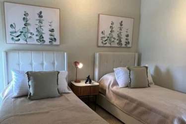 Drone shot of PH Brisas de Mar beachfront condos with pools, beach, tropical gardens at Playa Caracol Panama