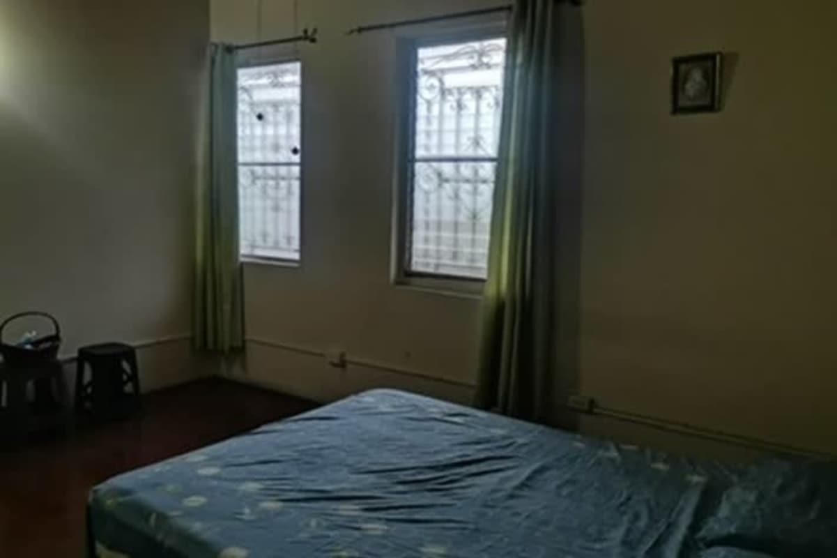 Bedroom with blue bedding green curtains window security bars Betania Panama City