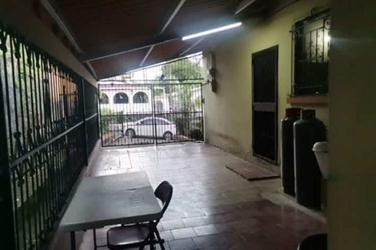 Gated covered parking with tiled floor and utility access in Betania Panama City