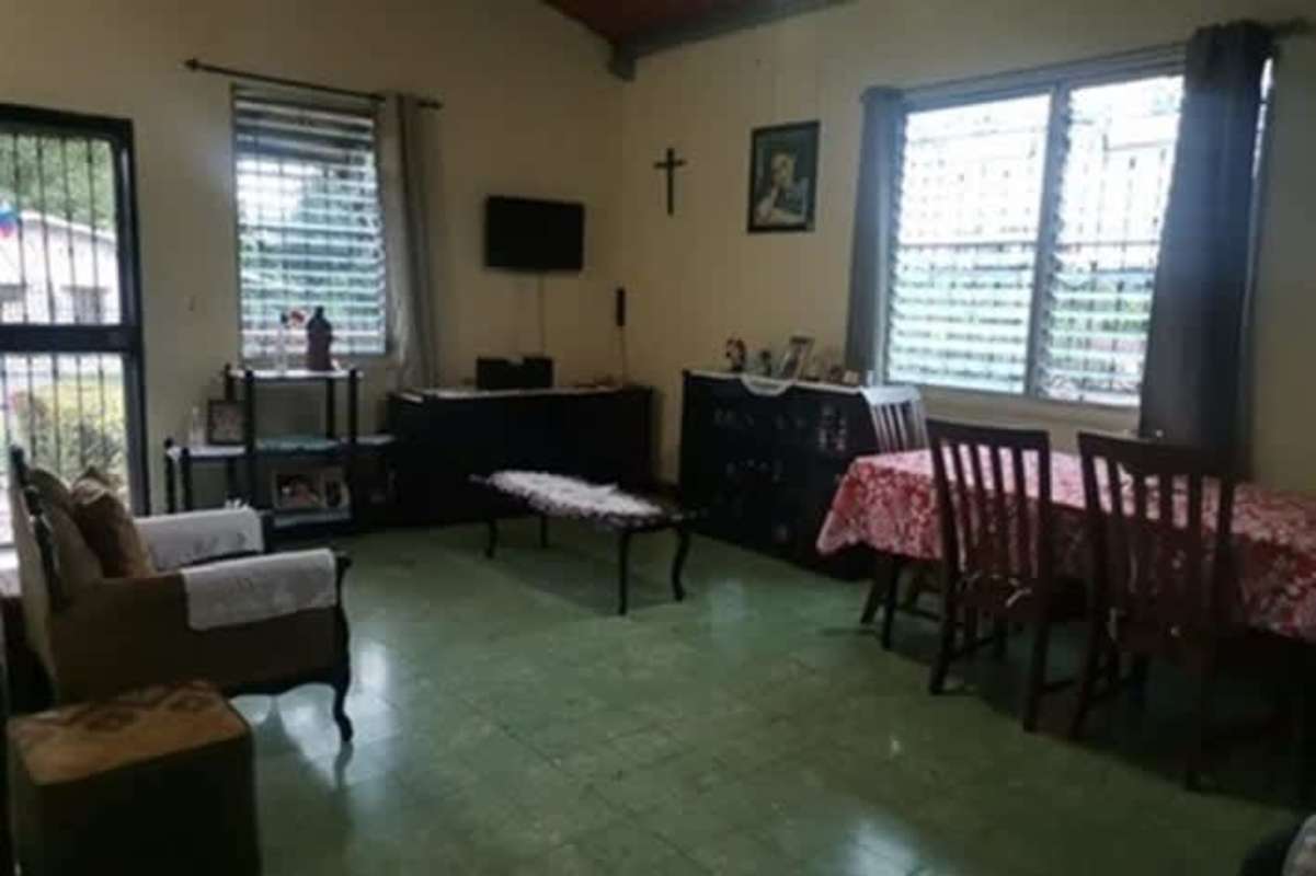 Spacious living dining room with tiled floors large windows green curtains Betania Panama City