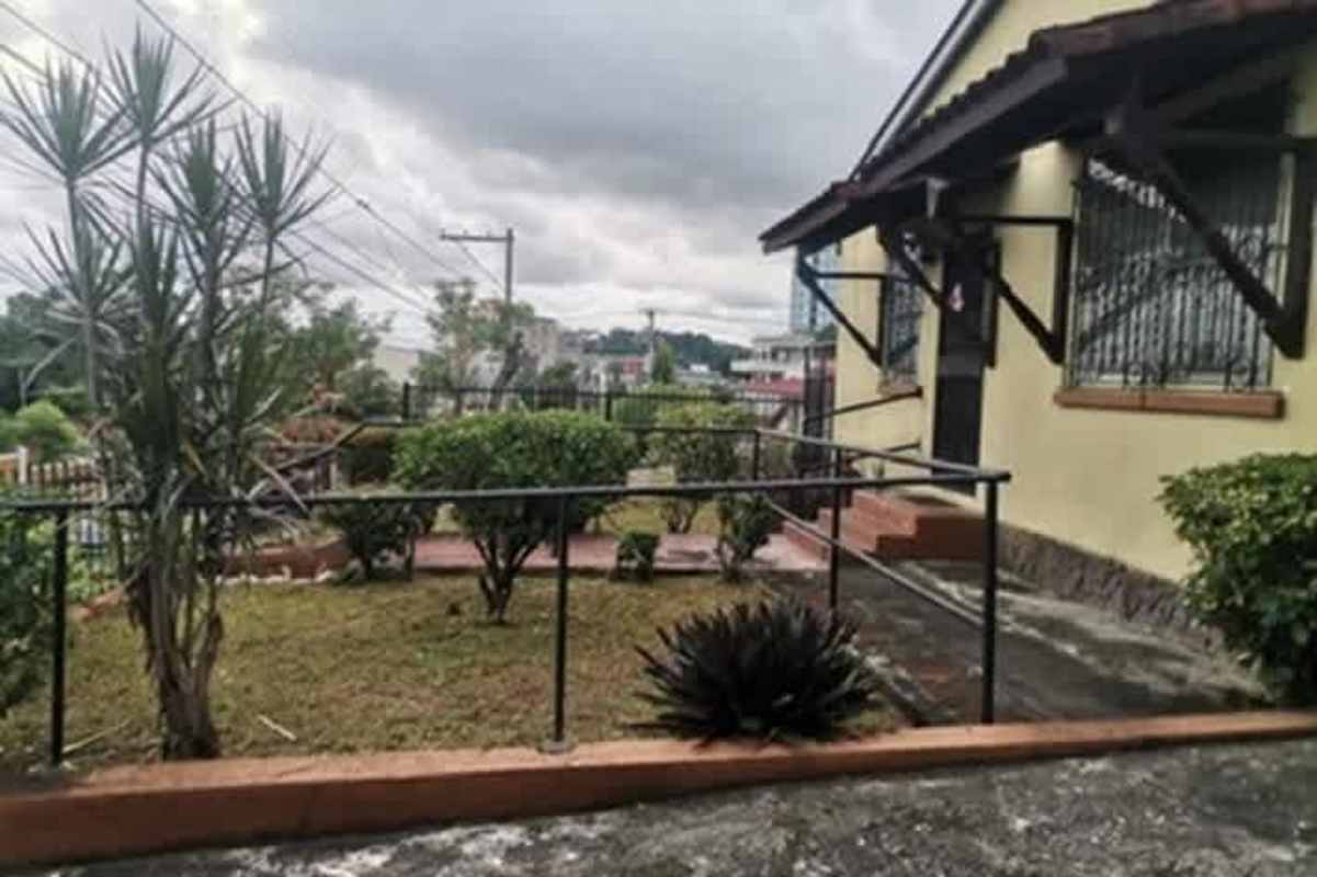 Entrance view with garden ramp fencing Betania Miraflores house Panama