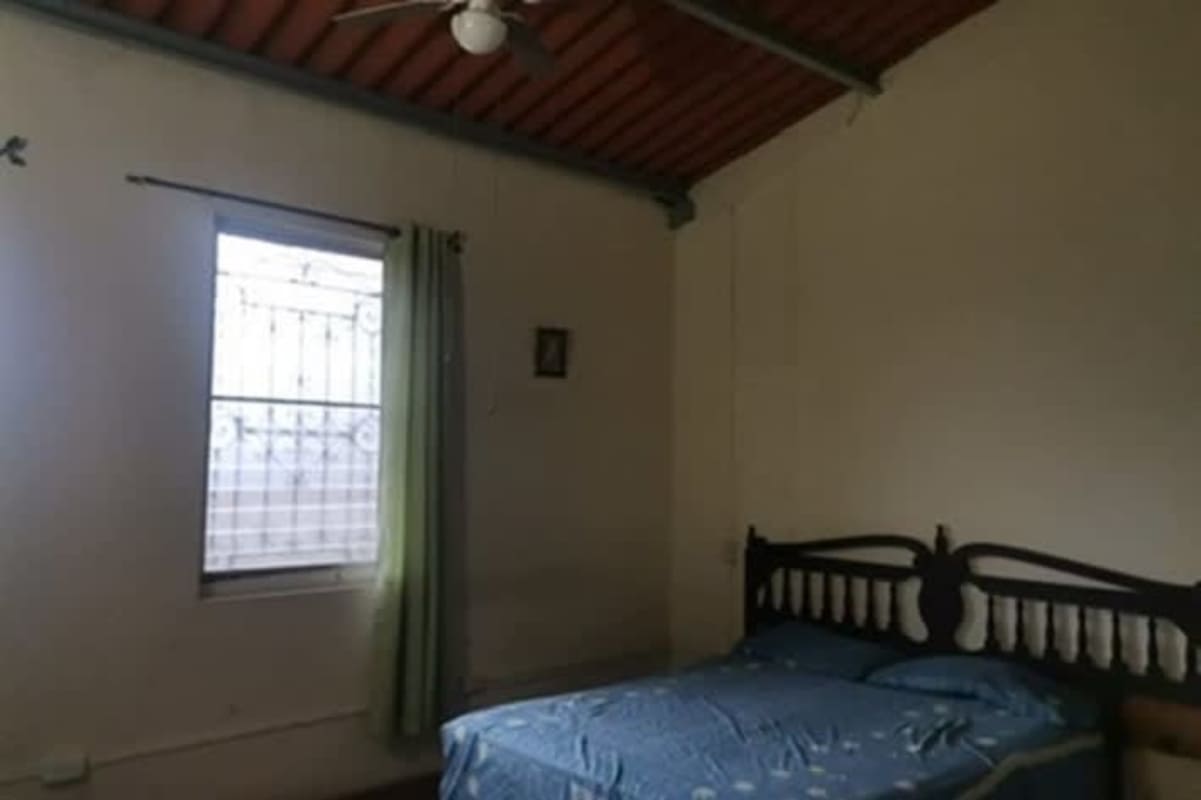 Bedroom with high ceiling ceiling fan window with security bars Betania Panama City