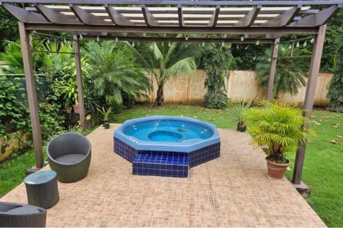 Beautiful tropical backyard garden with pergola and green lawn in Camino de Cruces Panama