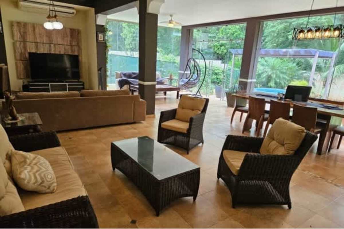 Spacious open plan living dining area with garden views and tropical decor in Camino de Cruces Panama