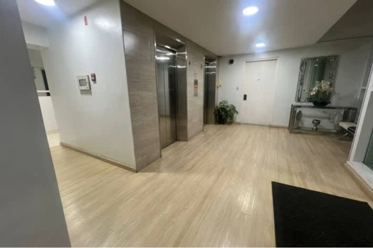 Bedroom with large window built-in closet and tile floors at PH El Mare Betania Panama