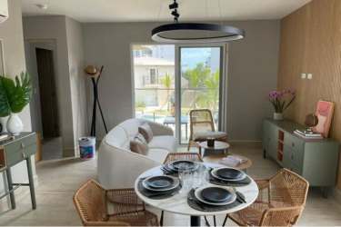 Open dining area with floor-to-ceiling windows facing balcony with Pacific Ocean at Playa Caracol Panama